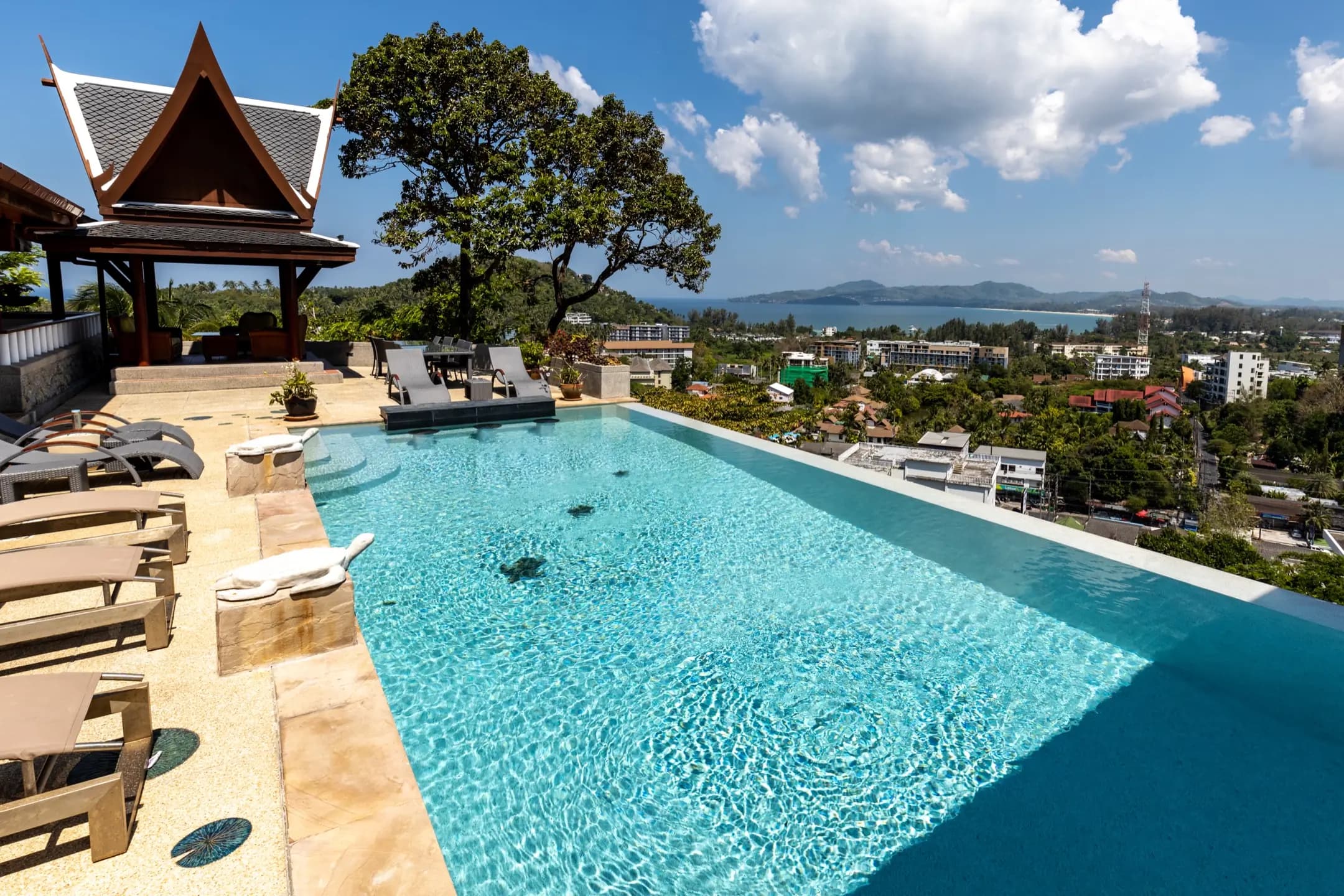 Turquoise infinity edge overlooking the town and distant islands