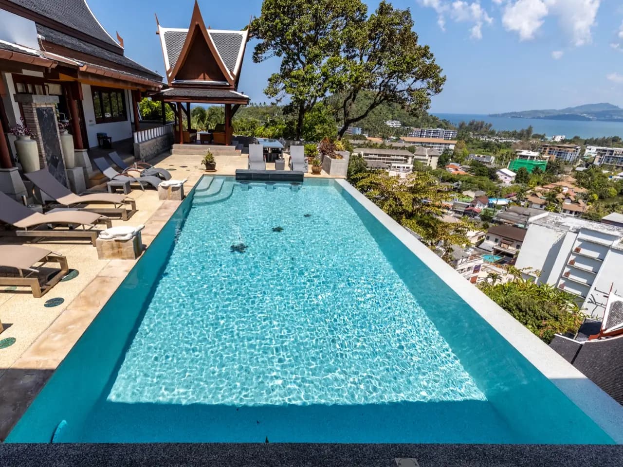 Full length of a light-aqua infinity pool with starfish mosaics