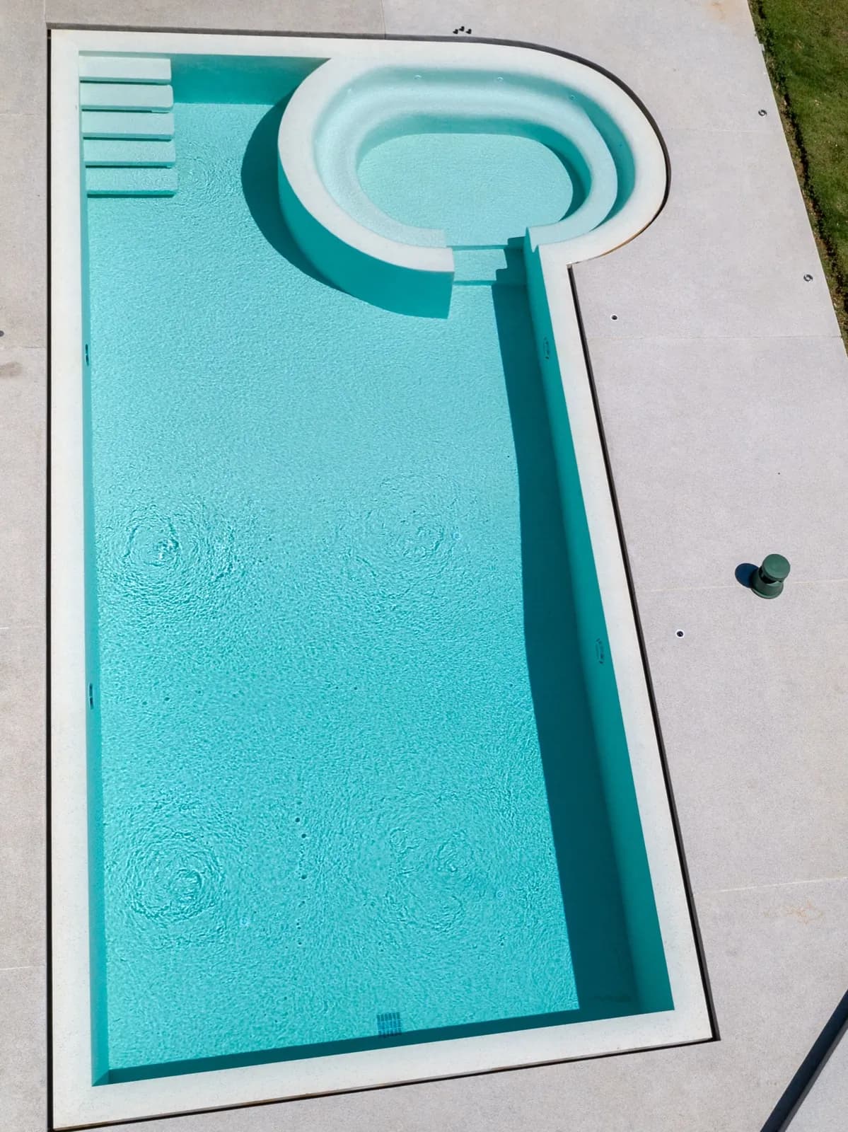 Overhead drone shot of the pool's rectangular body and round spa